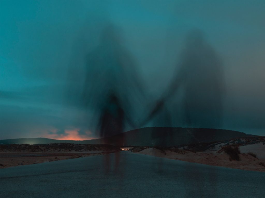 Long exposure picture of people holding hands. Photo by JR Korpa on Unsplash